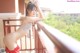 A woman in a bikini posing on a balcony.