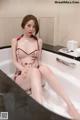 a woman sitting in a bathtub with her legs crossed