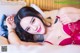 A woman in a red lingerie laying on a bed.